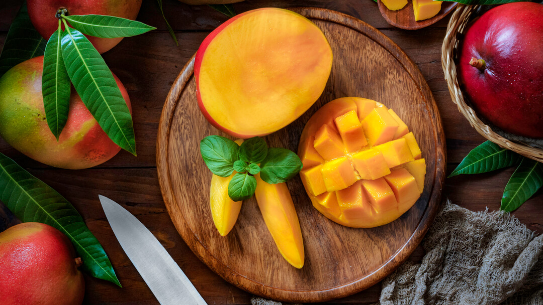 Ripe mango on a wooden board