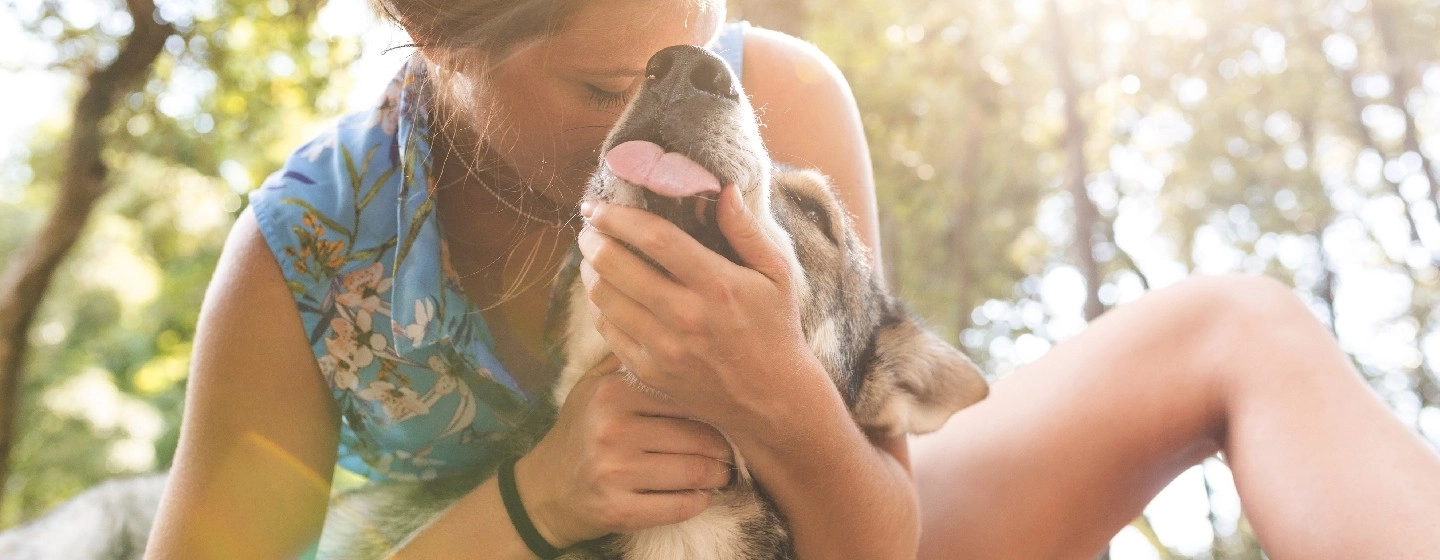 Woman cuddling her dog