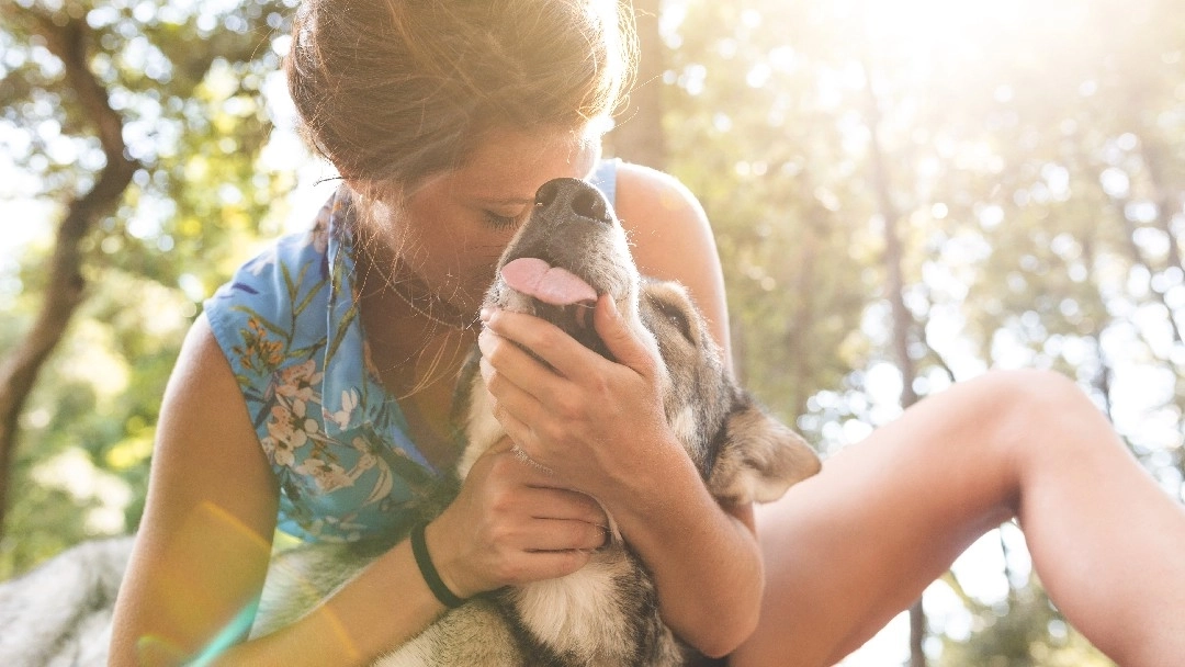 Woman cuddling her dog