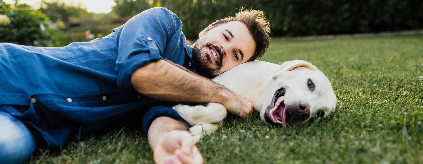 man lying down with his dog