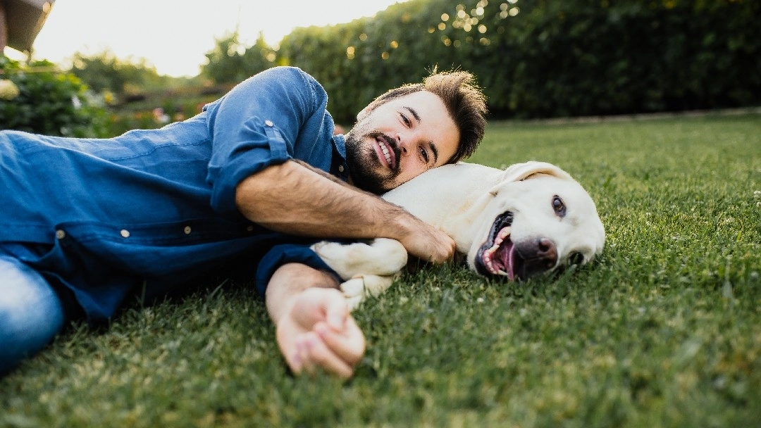 man lying down with his dog