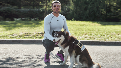 Man in jogging clothes with a dog