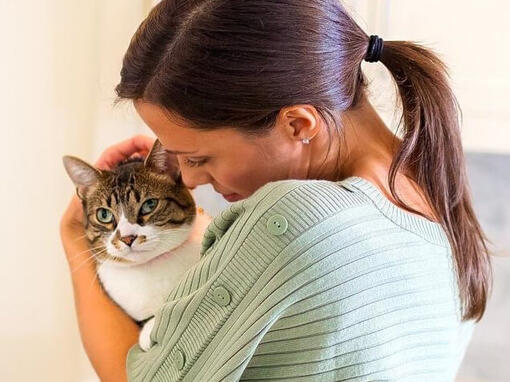Woman holding up Cat